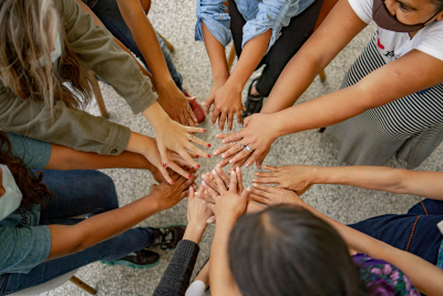 People putting their hands in a circle